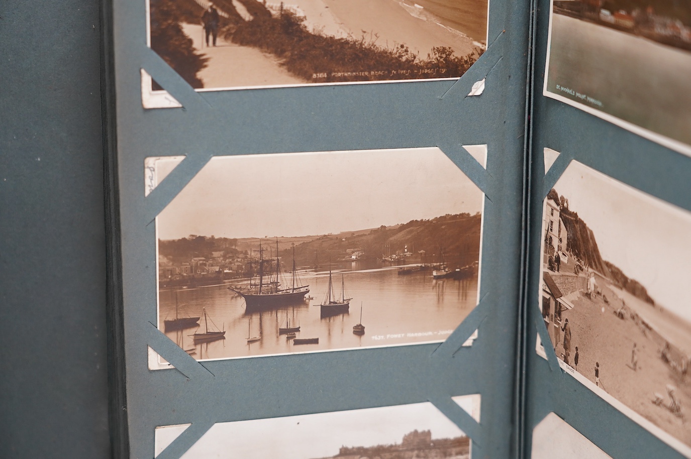 An Edwardian ‘The Cabinet’ postcard album, containing Edwardian and later postcards, mostly topographical. Condition - fair